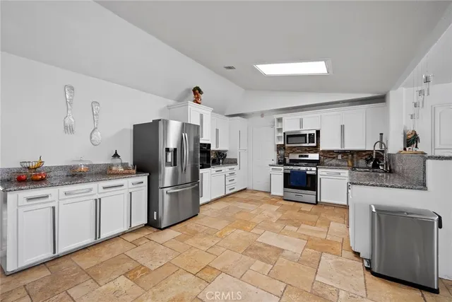 a kitchen with a sink stainless steel appliances and cabinets