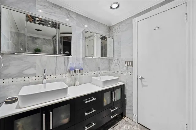 a bathroom with a double vanity sink and a mirror