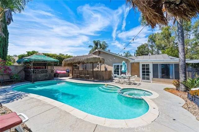 a view of a house with swimming pool and a chairs