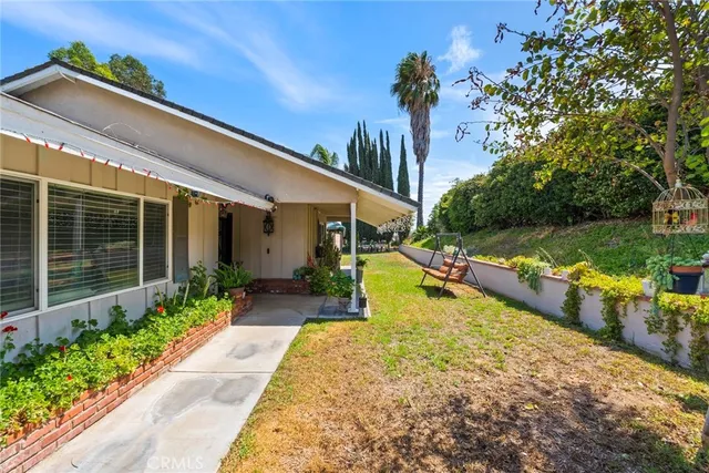 a view of a house with backyard and sitting area