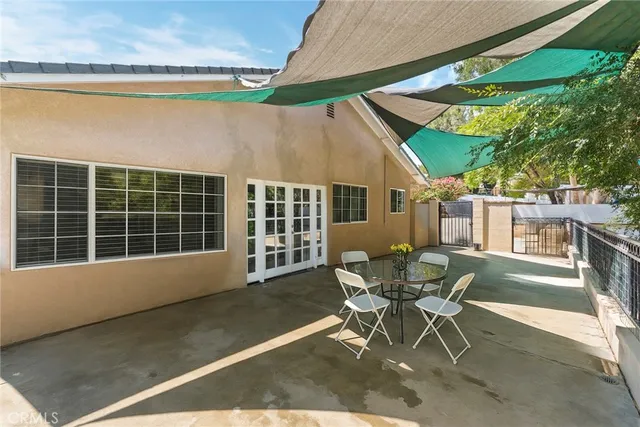 a view of a patio with table and chairs and potted plants