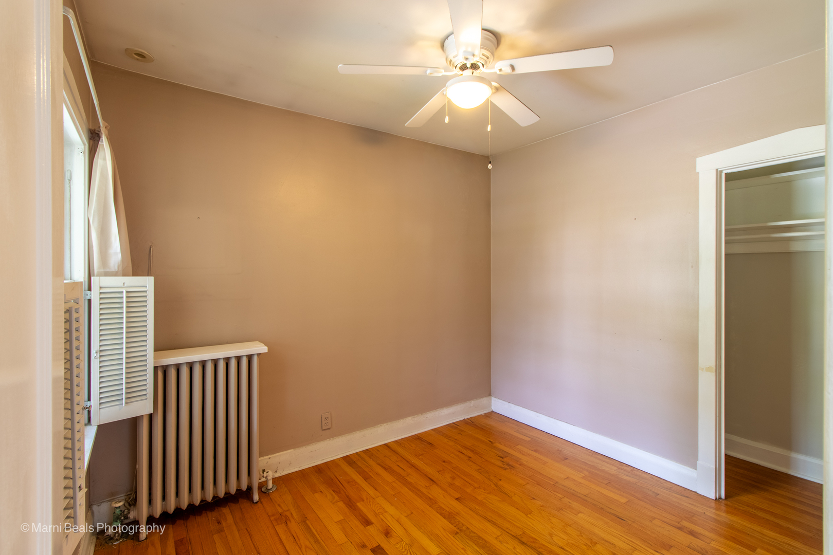 269 Shenstone Road Riverside, IL 60546 - Photo 13 of 25 an empty room with wooden floor fan and windows