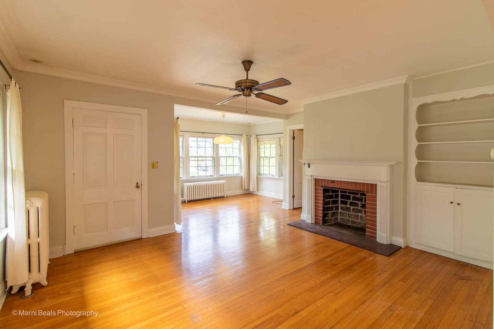 269 Shenstone Road Riverside, IL 60546 - Photo 3 of 25 an empty room with windows and a fireplace