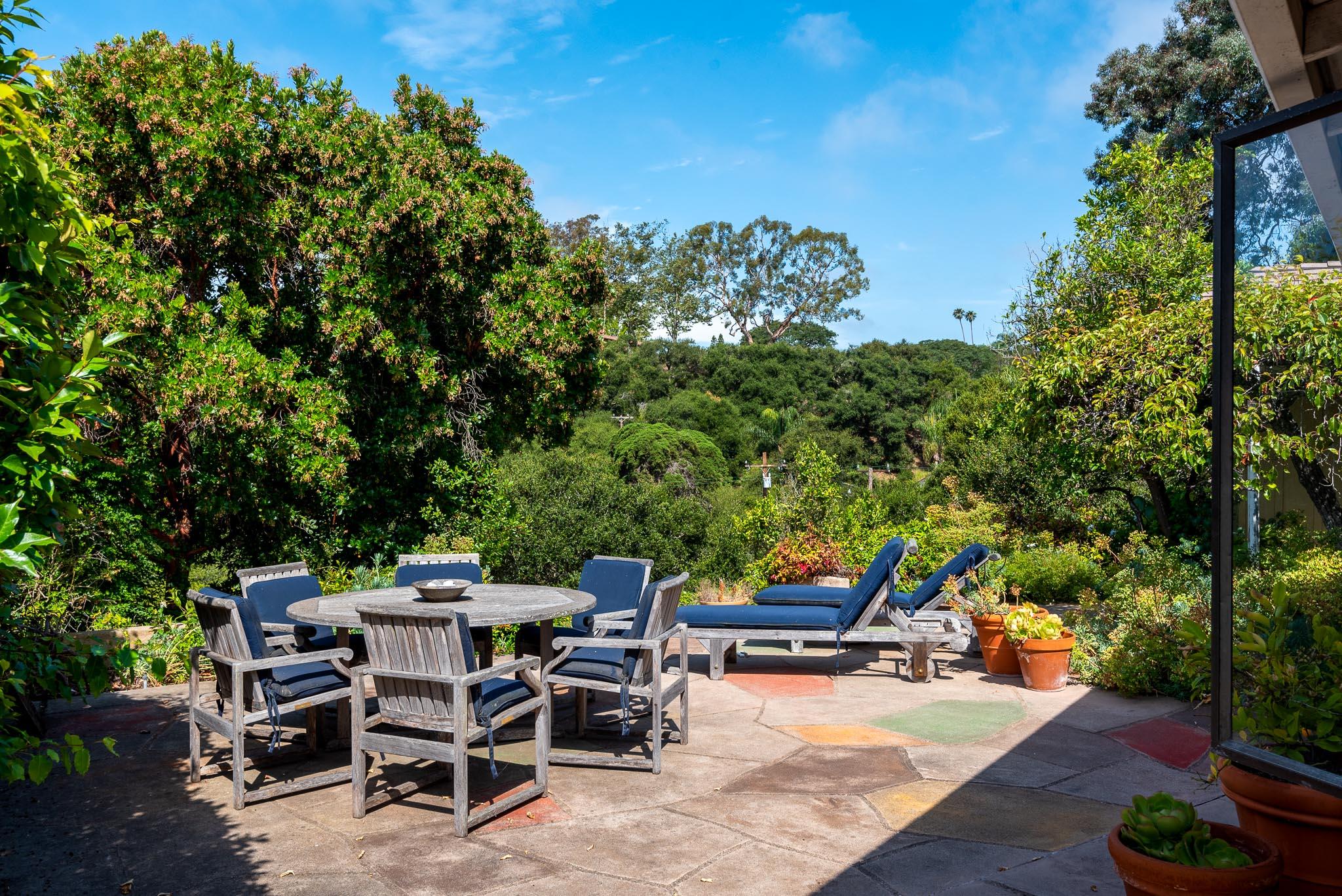895 Via Hierba Santa Barbara, CA 93110 - Photo 13 of 24 a view of a backyard with table and chairs and a barbeque