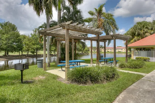 a living room with furniture a dining table and a potted plant