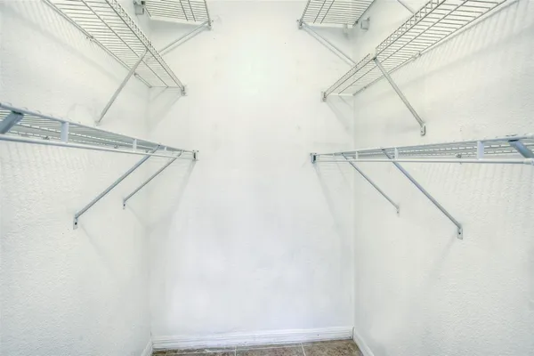 an empty room with fan and windows