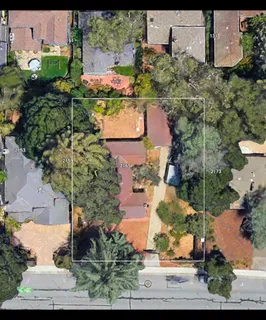 an aerial view of a houses with yard
