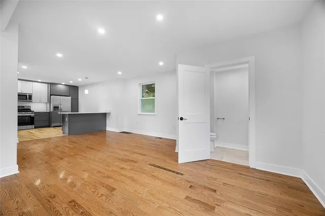 a view of a kitchen with a refrigerator and a window