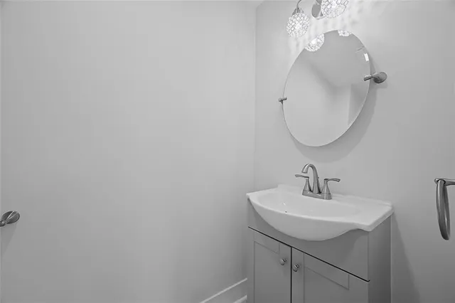a bathroom with a sink a mirror and vanity