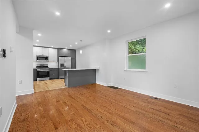 a view of a kitchen with a sink and a refrigerator