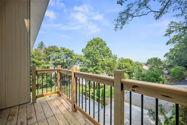 a view of a balcony with wooden floor