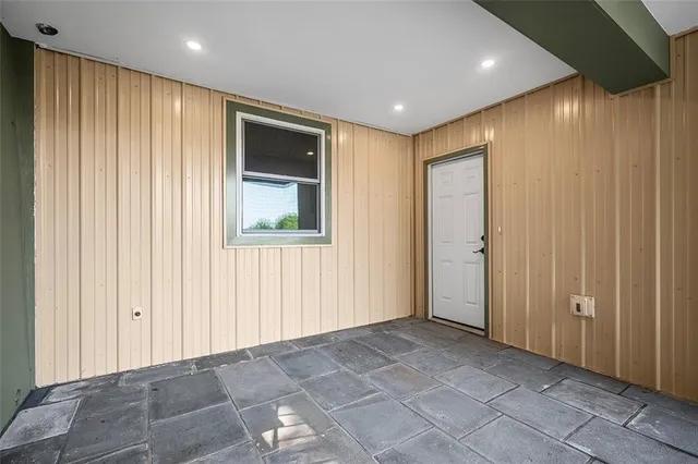 a view of a house with backyard and trees in the background