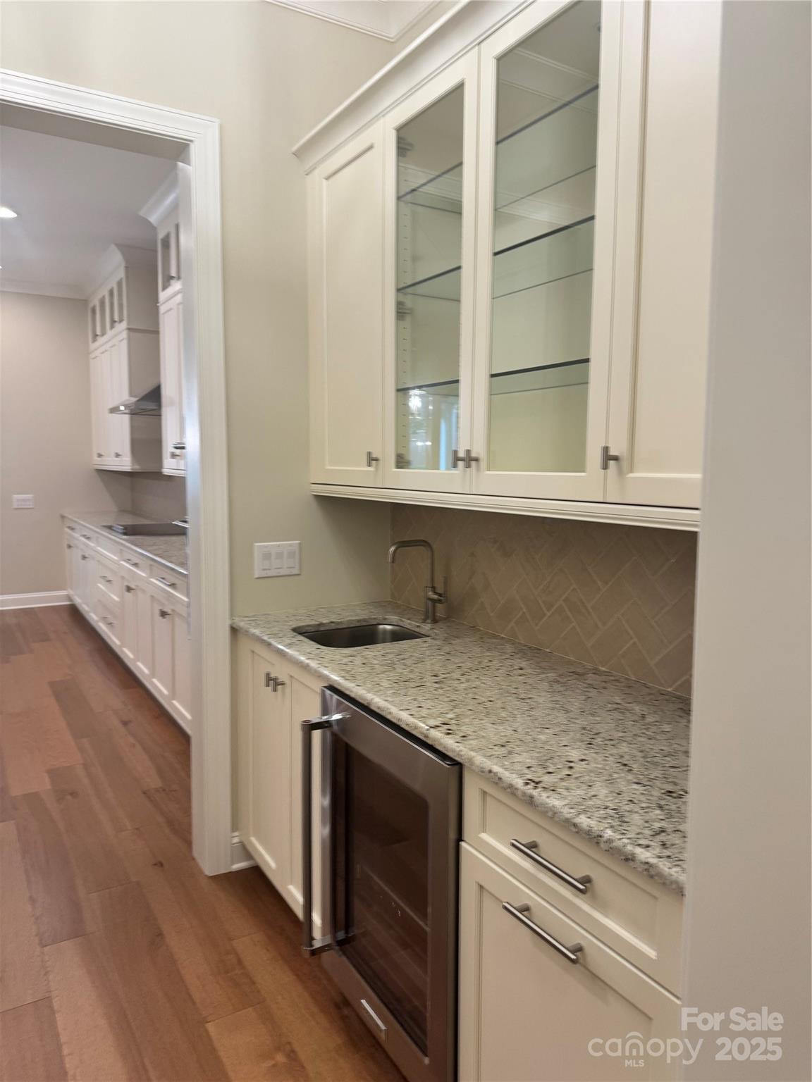 17728 Jetton Green Loop Cornelius, NC 28031 - Photo 5 of 7 a kitchen with granite countertop a stove and a sink