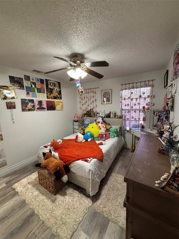 30 Oak Villa Road Canyon Lake, TX 78133 - Photo 14 of 29 a bedroom with furniture and a chandelier