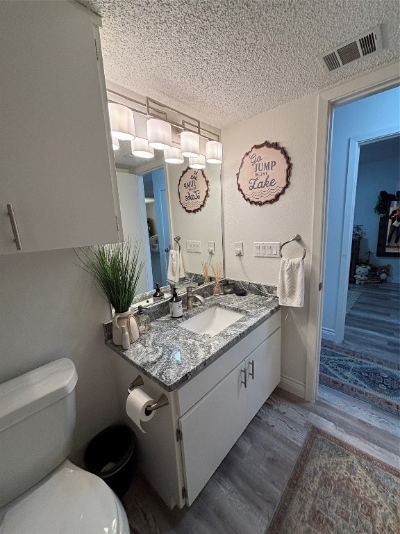 30 Oak Villa Road Canyon Lake, TX 78133 - Photo 22 of 29 a bathroom with a granite countertop sink and a toilet