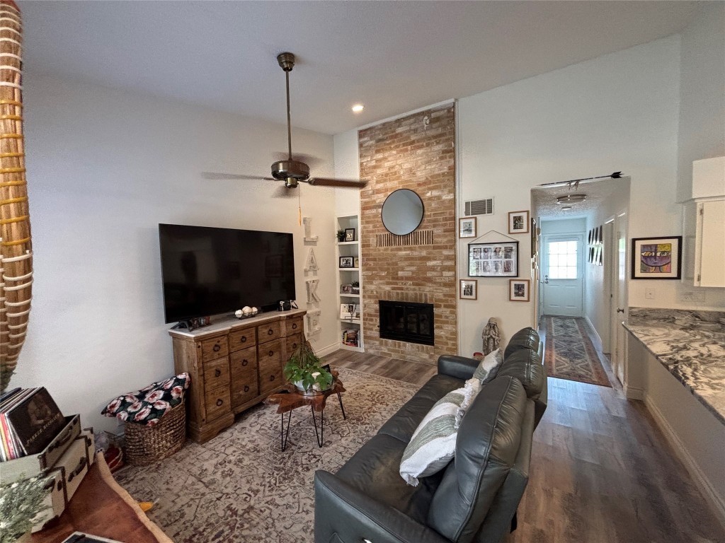 30 Oak Villa Road Canyon Lake, TX 78133 - Photo 4 of 29 a living room with furniture a flat screen tv and a fireplace