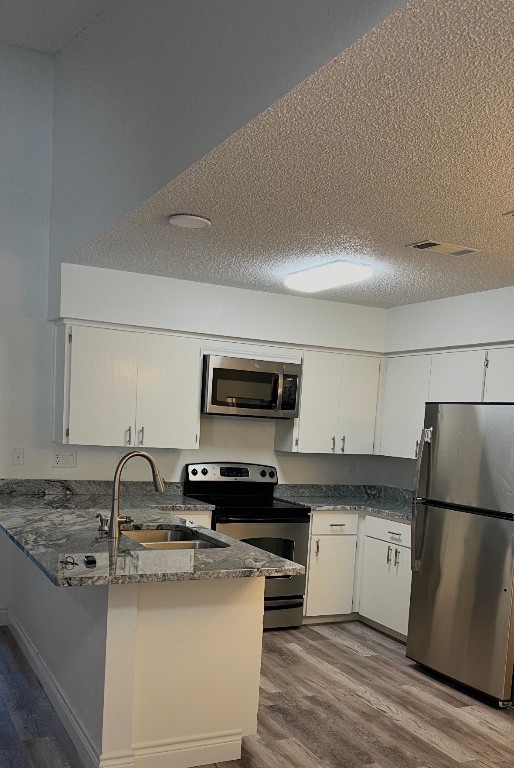 30 Oak Villa Road Canyon Lake, TX 78133 - Photo 8 of 29 a kitchen with a sink a stove top oven and refrigerator