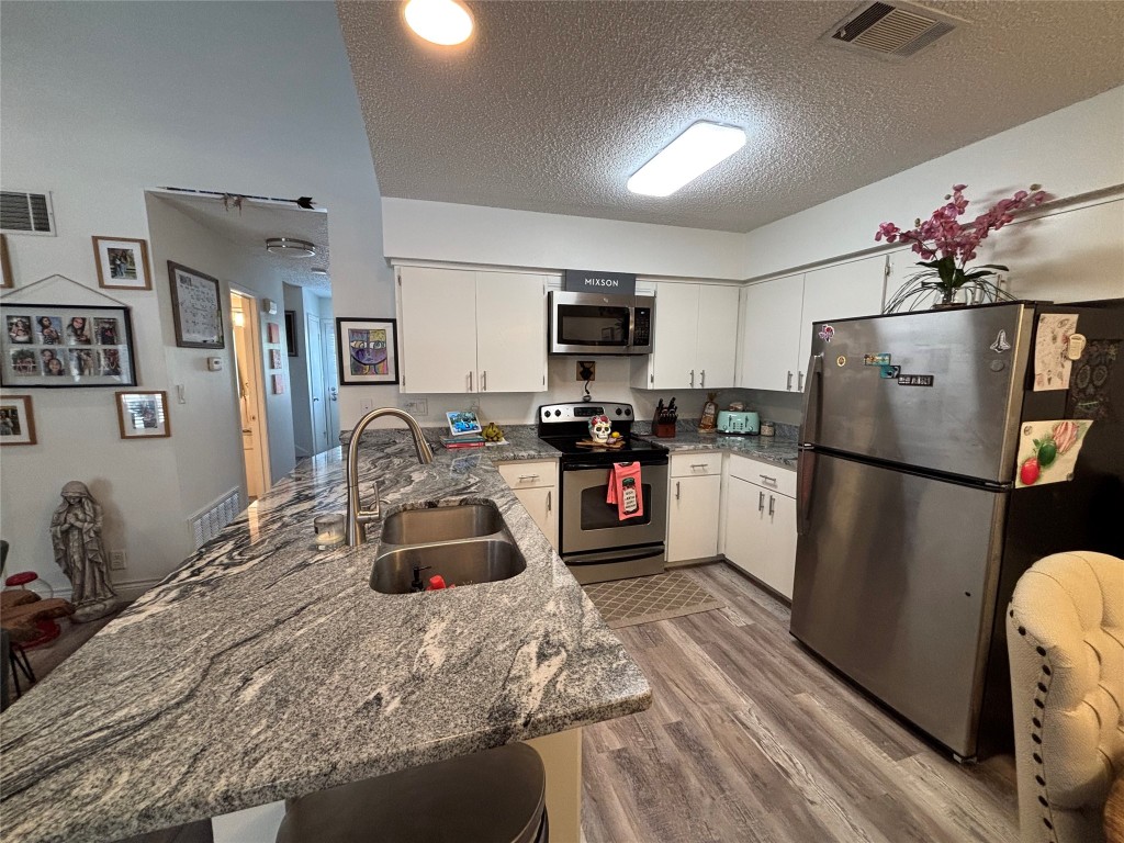 30 Oak Villa Road Canyon Lake, TX 78133 - Photo 9 of 29 a kitchen with stainless steel appliances granite countertop a refrigerator sink and stove