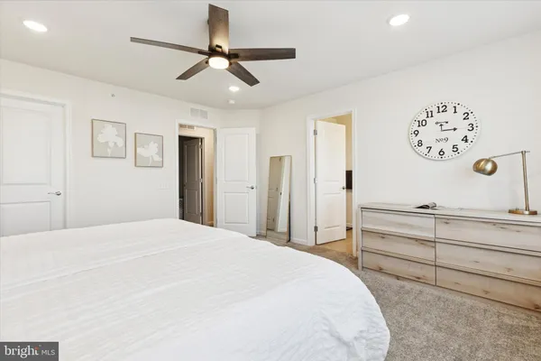 a bedroom with a large bed and a dresser