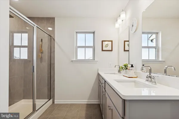 a bathroom with a sink a mirror and a shower