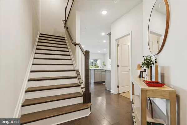 a view of entryway and hall with wooden floor