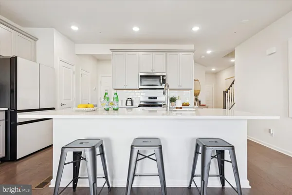 a kitchen with stainless steel appliances a refrigerator and a stove top oven