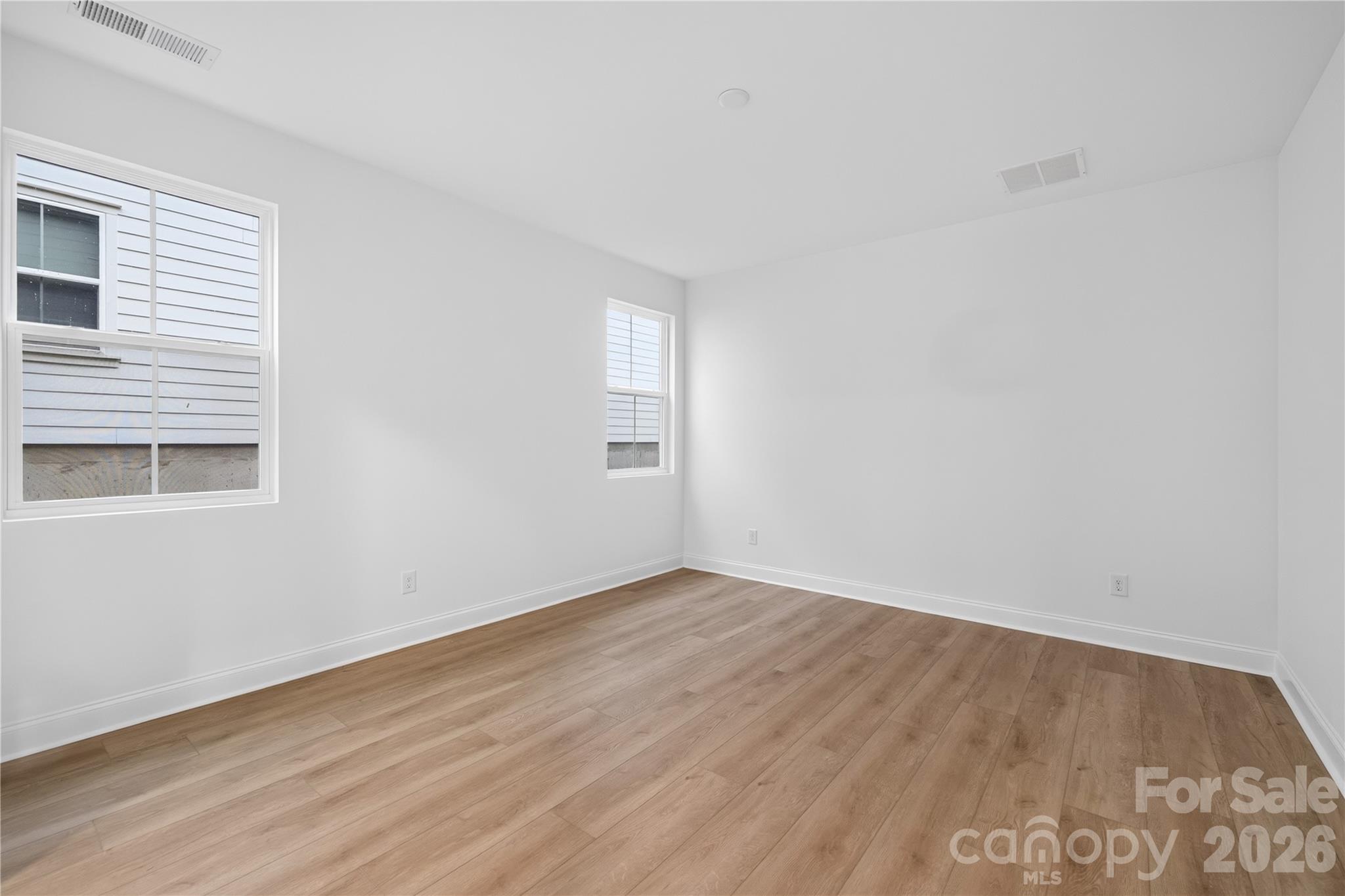 416 Celestial Drive Tega Cay, SC 29708 - Photo 10 of 21 a view of an empty room with wooden floor and a window