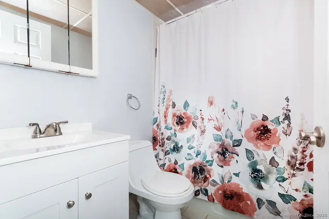 a bathroom with a sink toilet and mirror