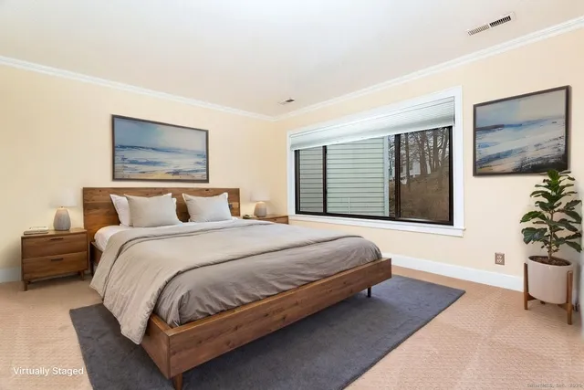 a bedroom with bed and a potted plant