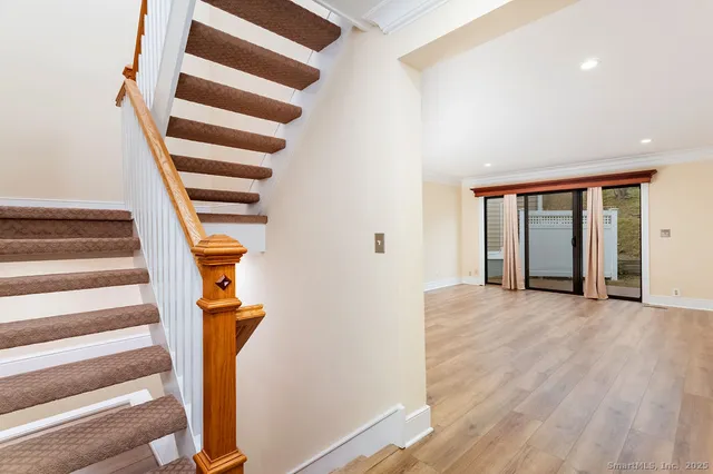 a view of entryway with wooden floor and windows