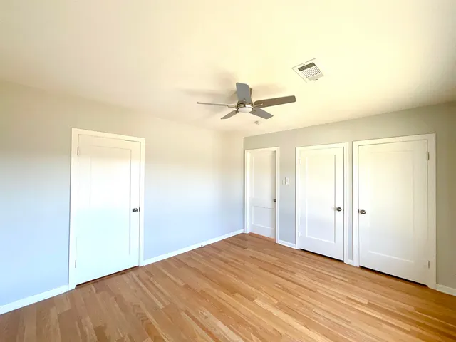 a view of a room with a ceiling fan