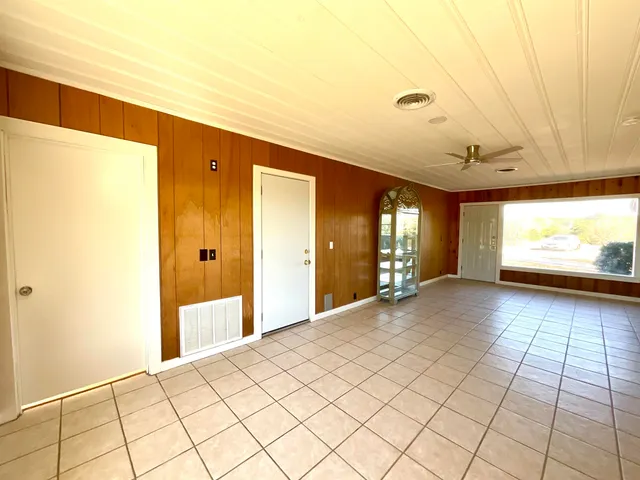 a view of a livingroom with an empty space and a window