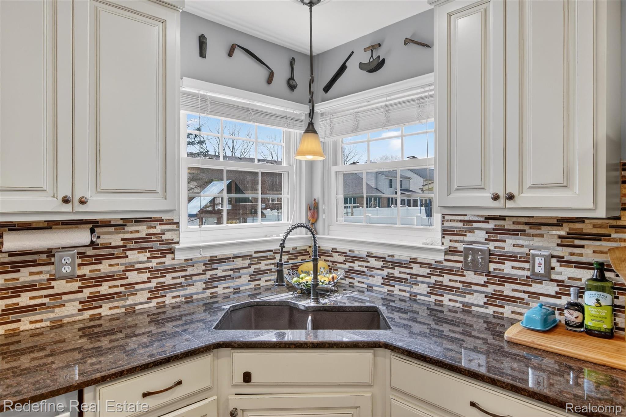 45663 Radnor Road Canton, MI 48187 - Photo 12 of 51 Kitchen featuring dark stone counters, healthy amount of natural light, and hanging light fixtures