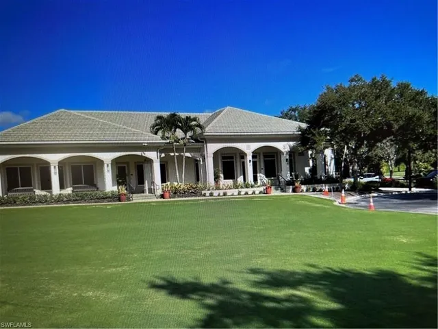 a front view of a house with swimming pool having outdoor seating