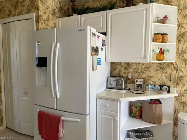 a white refrigerator freezer sitting inside of a kitchen