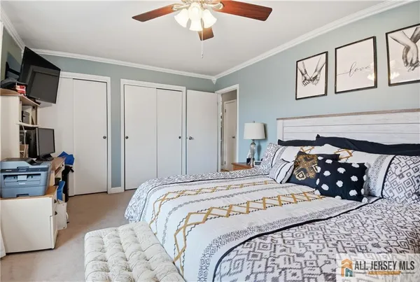 a bedroom with double bed and a tv