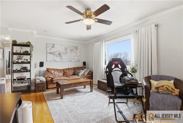 a living room with furniture a rug and a window