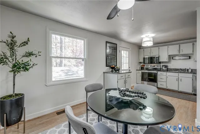 a view of a dining room with furniture window and wooden floor