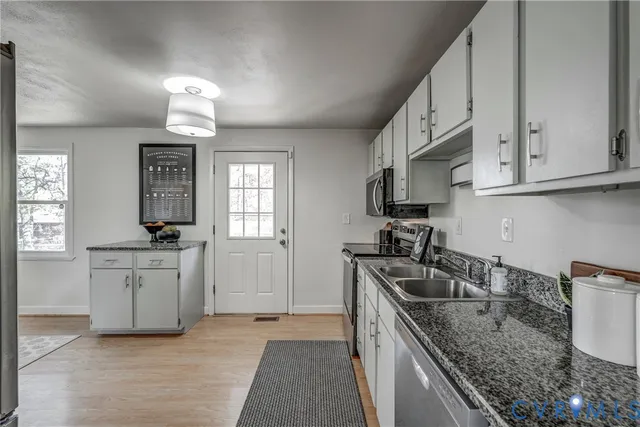 a kitchen with a sink stove and cabinets