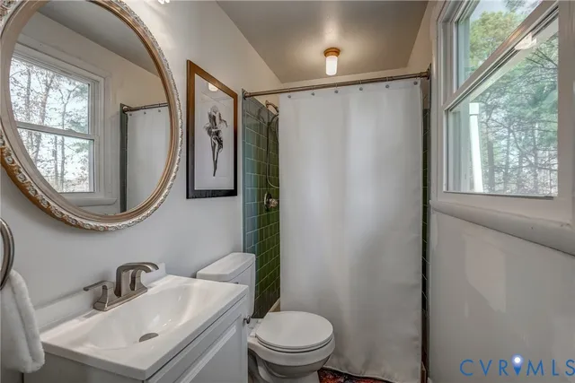 a bathroom with a toilet a sink and a mirror