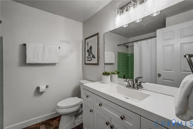 a bathroom with a sink toilet and mirror