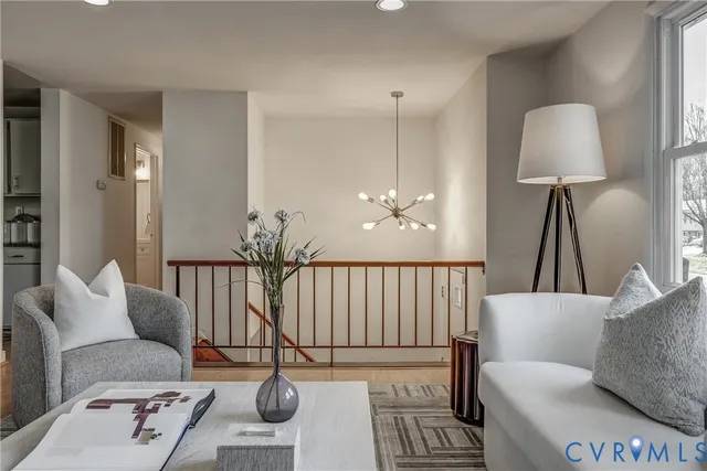 a living room with furniture and a lamp