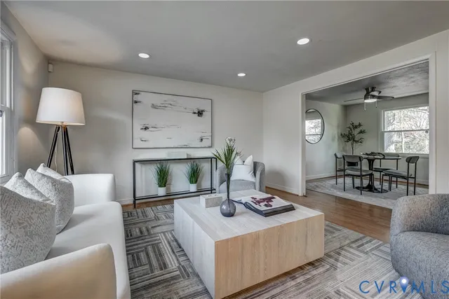 a living room with furniture a table and a fireplace