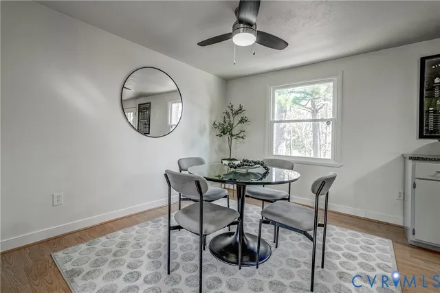 a view of a dining room with furniture and a window