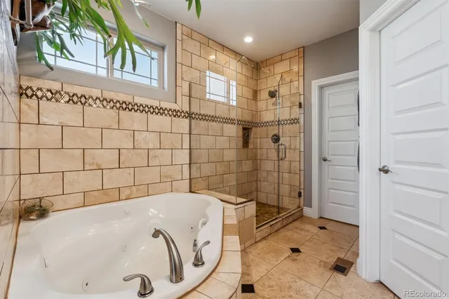 a bathroom with a bathtub and shower