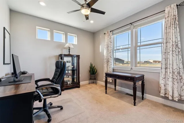 a view of a workspace with furniture and a window
