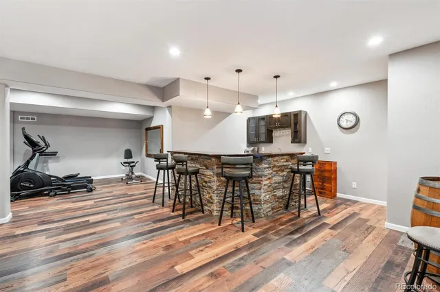 a view of a kitchen with furniture and a wooden floor