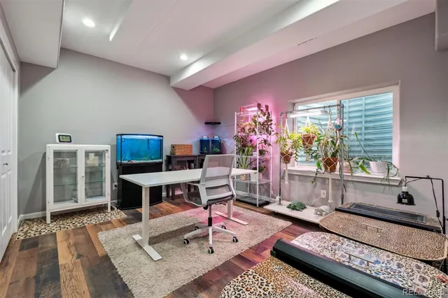 a living room with furniture a flat screen tv and a table