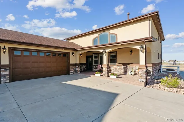 a view of a patio with table and chairs and potted plants
