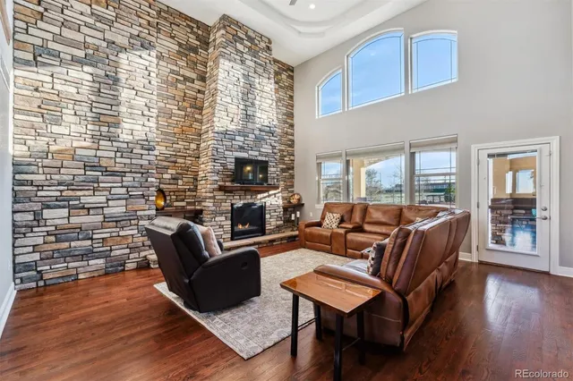 a living room with furniture wooden floor and a fireplace
